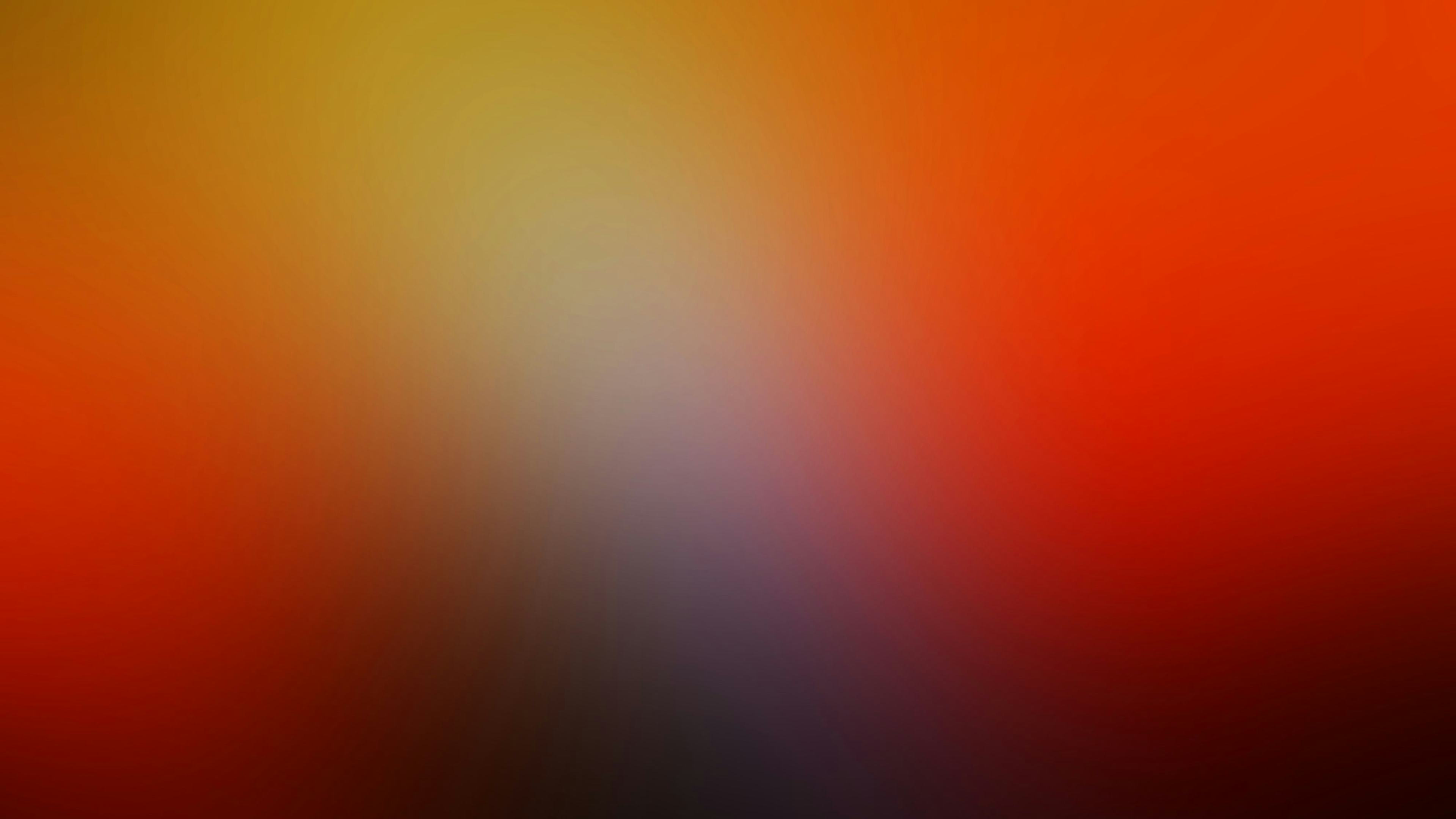 red, orange, yellow, and grey blur gradient background