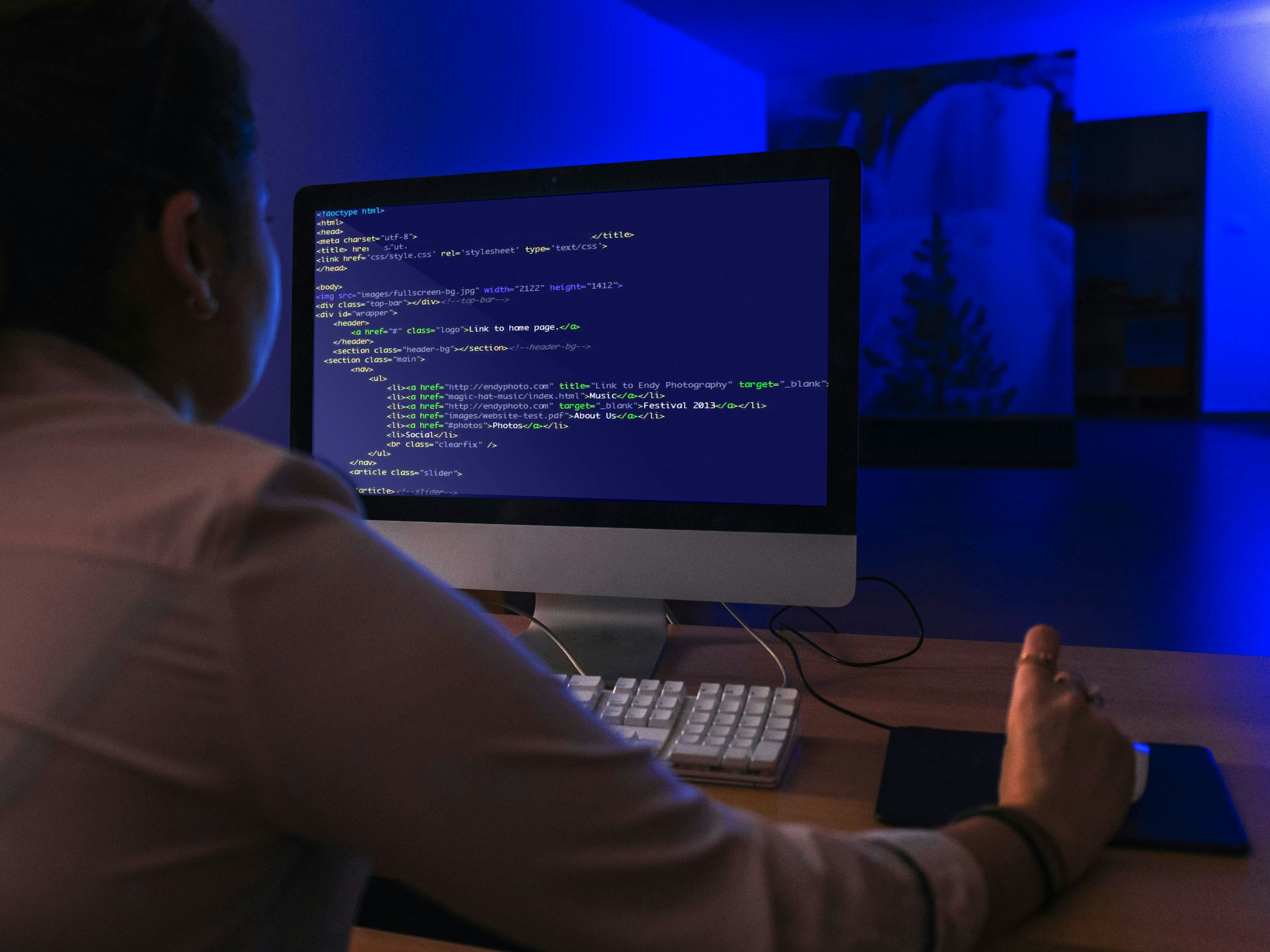Man coding on desktop 